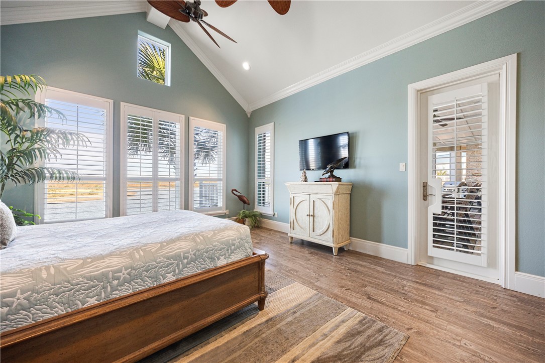 13806 Captains Row Corpus Christi, TX 78418 - Photo 15 of 40 a bedroom with a bed and a flat screen tv