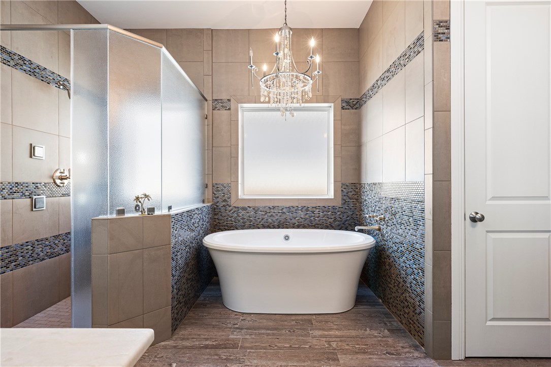 13806 Captains Row Corpus Christi, TX 78418 - Photo 18 of 40 a bathroom with a bathtub and window