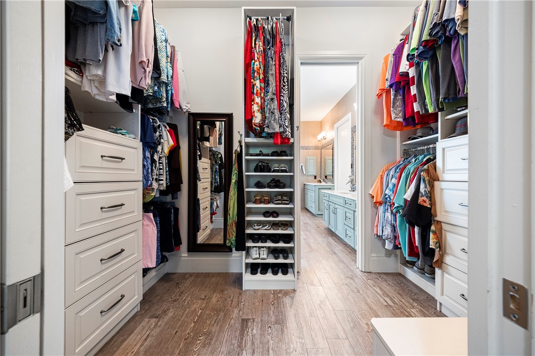 13806 Captains Row Corpus Christi, TX 78418 - Photo 20 of 40 a view of walk in closet with clothes and shoes