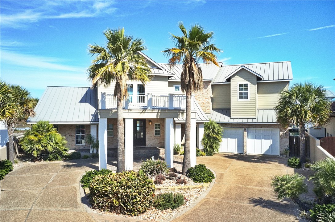 13806 Captains Row Corpus Christi, TX 78418 - Photo 2 of 40 a front view of a house with a yard and garage