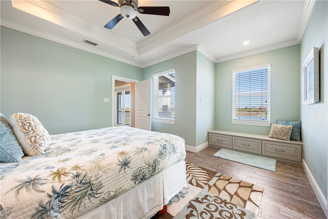13806 Captains Row Corpus Christi, TX 78418 - Photo 24 of 40 a spacious bedroom with a bed and wooden floor