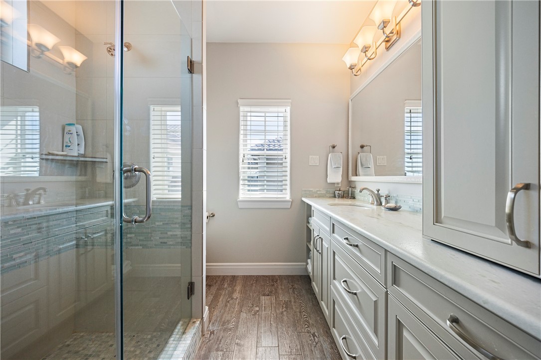 13806 Captains Row Corpus Christi, TX 78418 - Photo 25 of 40 a bathroom with a double vanity sink a mirror and a shower