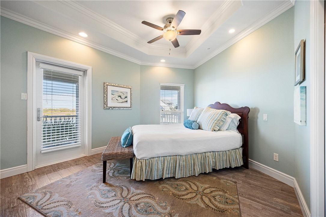 13806 Captains Row Corpus Christi, TX 78418 - Photo 28 of 40 a bedroom with a bed and a table with chair