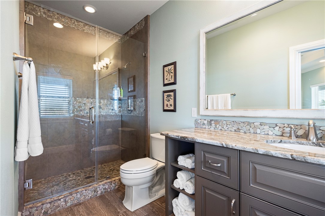 13806 Captains Row Corpus Christi, TX 78418 - Photo 29 of 40 a bathroom with a sink a toilet and shower