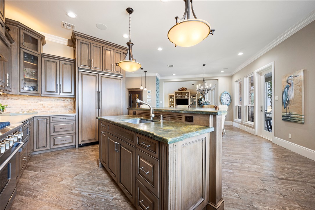 13806 Captains Row Corpus Christi, TX 78418 - Photo 8 of 40 a kitchen with stainless steel appliances granite countertop a sink a stove top oven a counter space and cabinets
