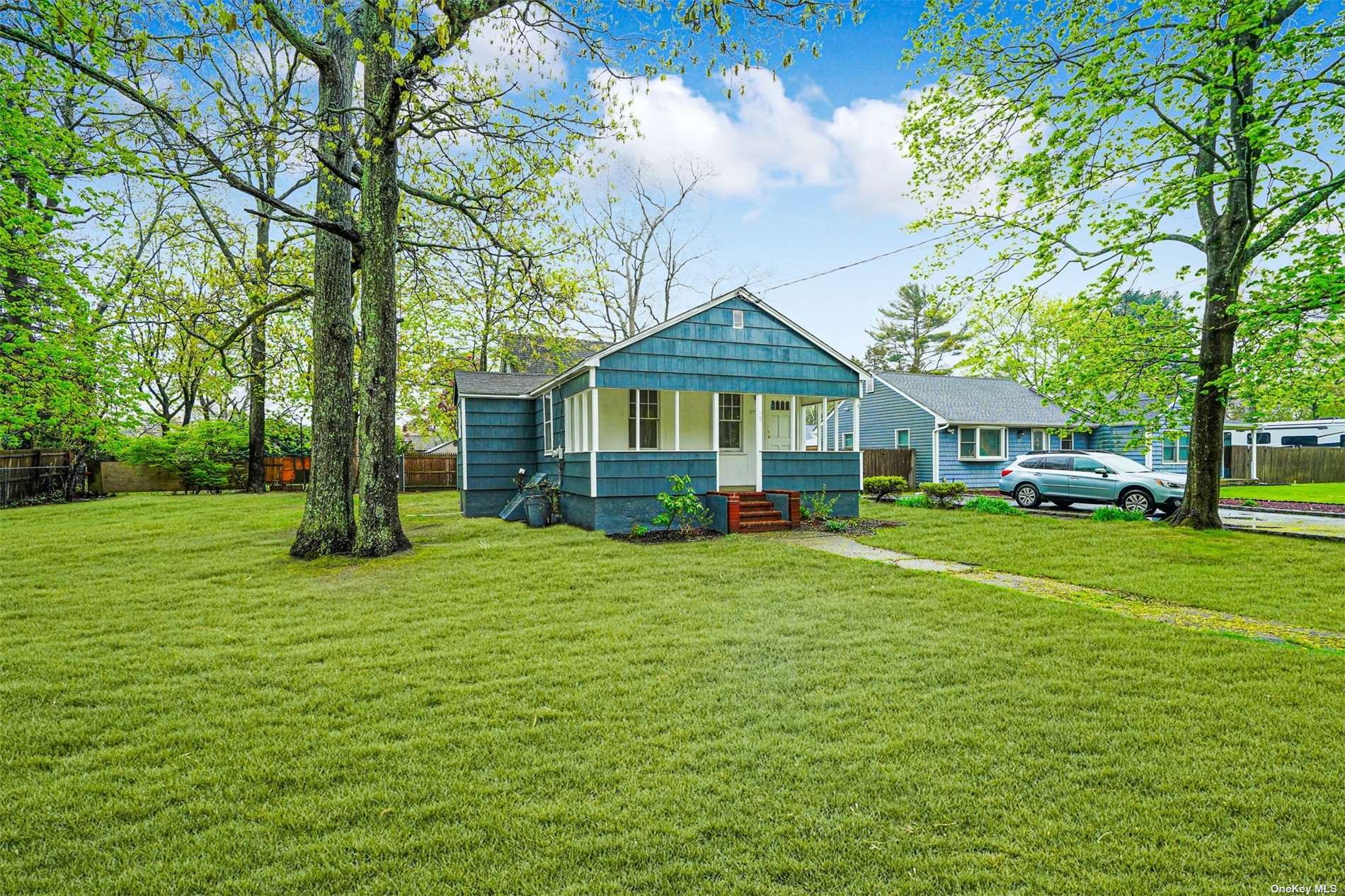39 Park Boulevard Yaphank, NY 11980 - Photo 1 of 1 a front view of a house with a garden