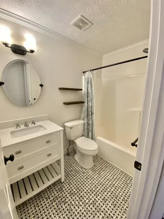 a kitchen with a sink a stove and cabinets