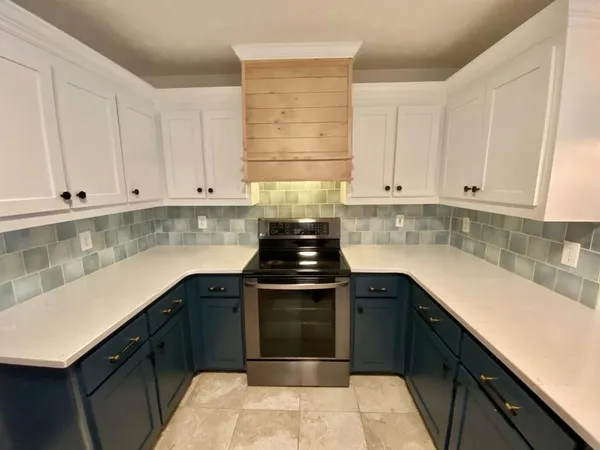 a open kitchen with a sink a counter top space and cabinets