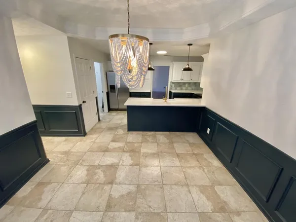 a kitchen with stainless steel appliances granite countertop a refrigerator and a sink