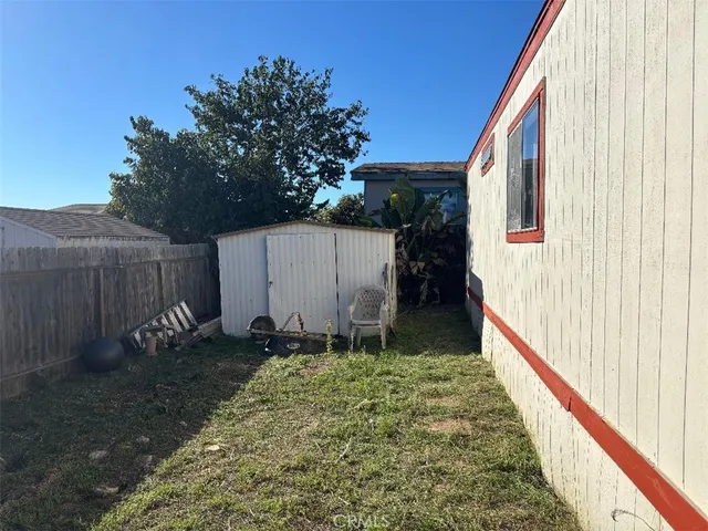 a view of a backyard with plants and slide