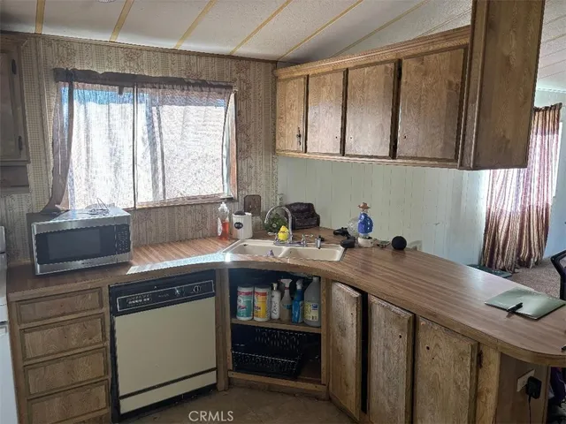 a kitchen that has a sink and a stove in it