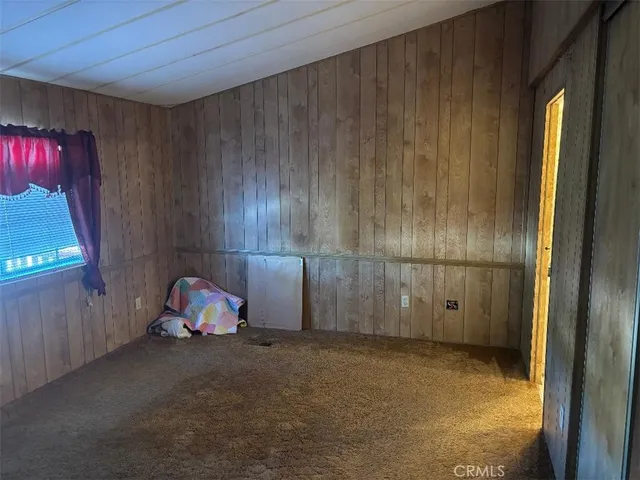 a view of a room with wooden floor and windows