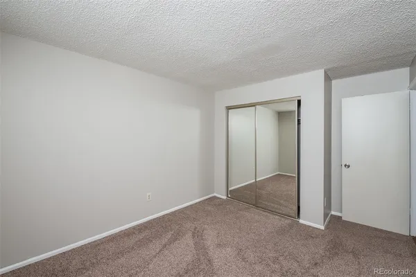 a view of an empty room and closet in a room