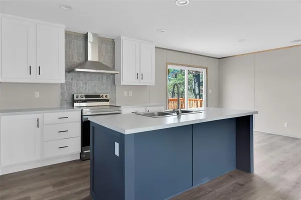 a kitchen with a sink stove and cabinets