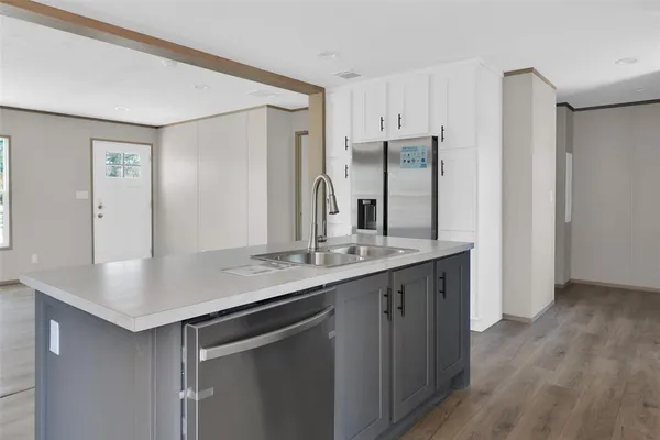 a kitchen with stainless steel appliances granite countertop a sink and refrigerator