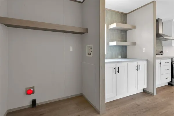 a view of storage and utility room with two washing machine