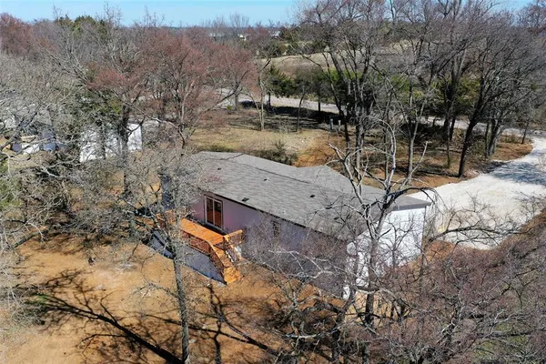 a view of a house with a yard covered with snow