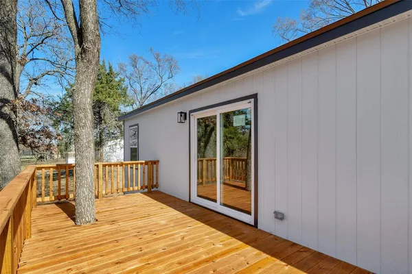 a view of backyard with a deck and wooden floor