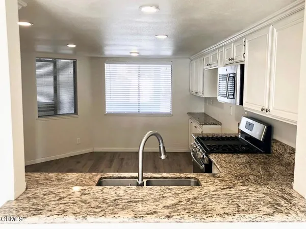 a view of a kitchen with a sink and a stove