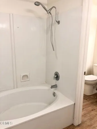 a bathroom with a bathtub and a toilet