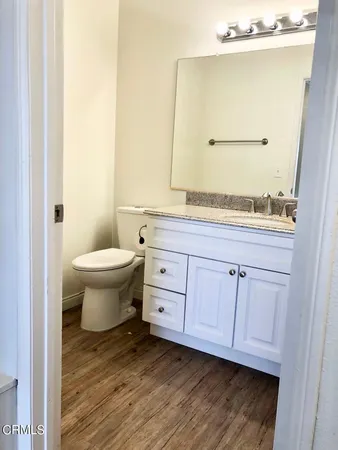 a bathroom with a sink a toilet and mirror