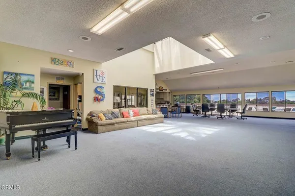 a living room with lots of furniture and a large window