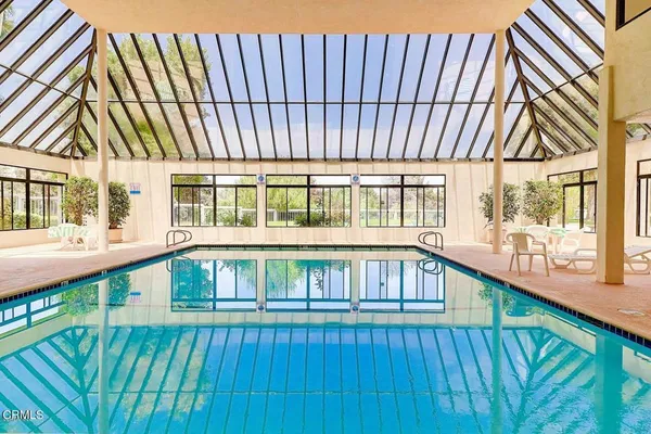 a view of a house with pool and deck