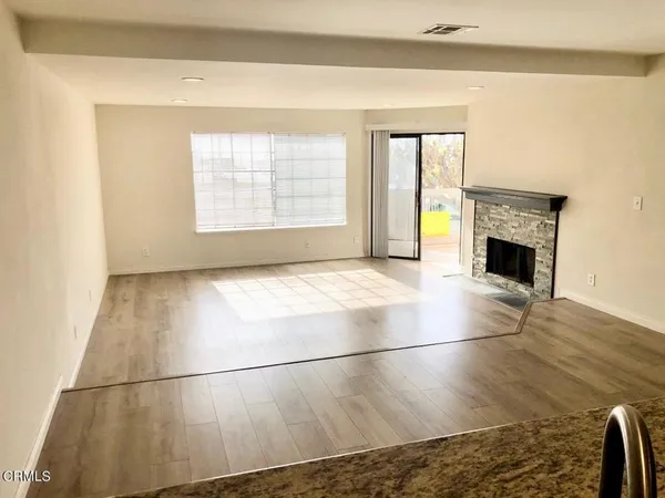 a view of a livingroom with a fireplace and a window