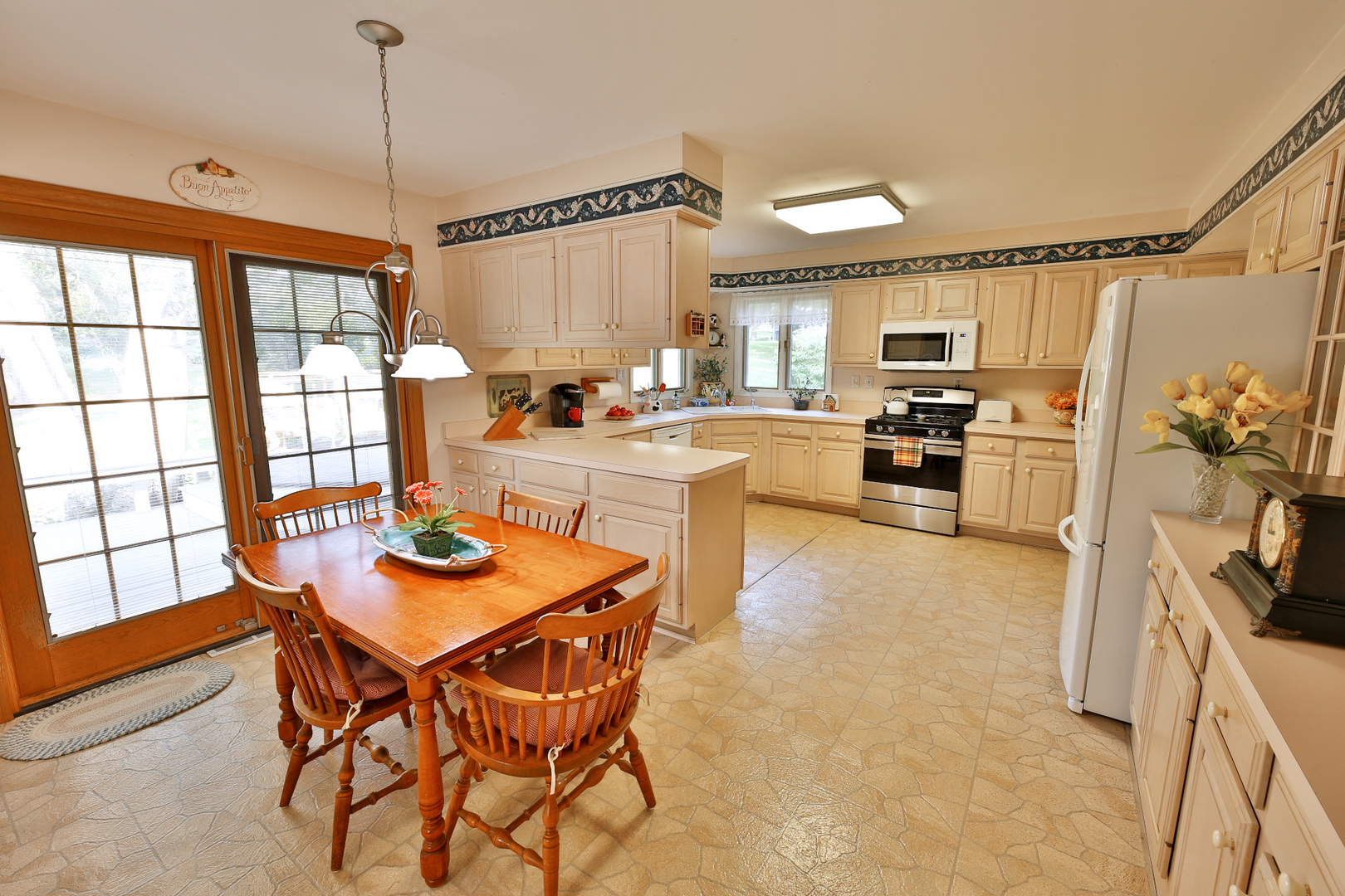 6N397 Corron Road St. Charles, IL 60175 - Photo 17 of 29 a kitchen with stainless steel appliances wooden floor dining table and chairs
