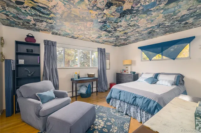 a bedroom with furniture and a large window