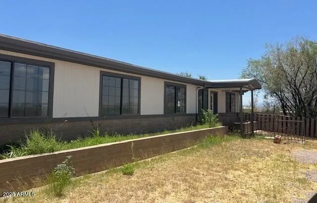 a view of house with a yard
