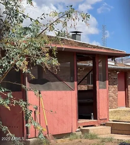 a view of a house with a tree