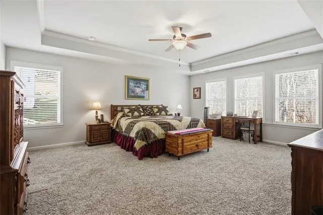 a spacious bedroom with a bed and glass door