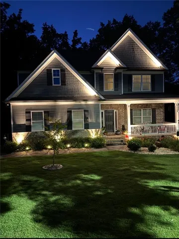 a front view of a house with a garden