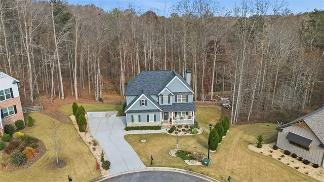 a view of a house with a backyard