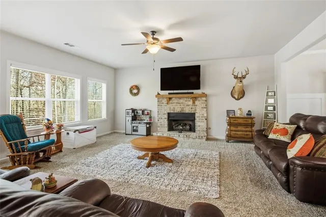 a living room with furniture a fireplace and a flat screen tv