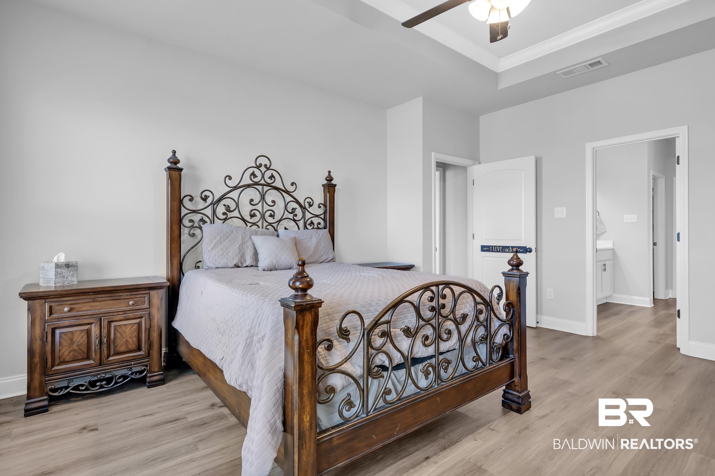 1176 Stella Road Foley, AL 36535 - Photo 17 of 40 Bedroom featuring light wood finished floors, ceiling fan, ornamental molding, and connected bathroom