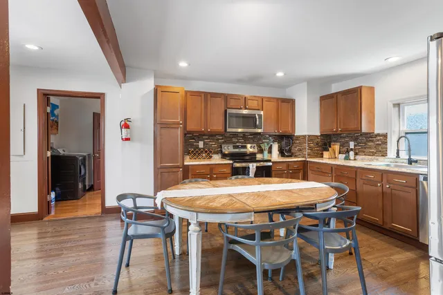 a large kitchen with a table and chairs