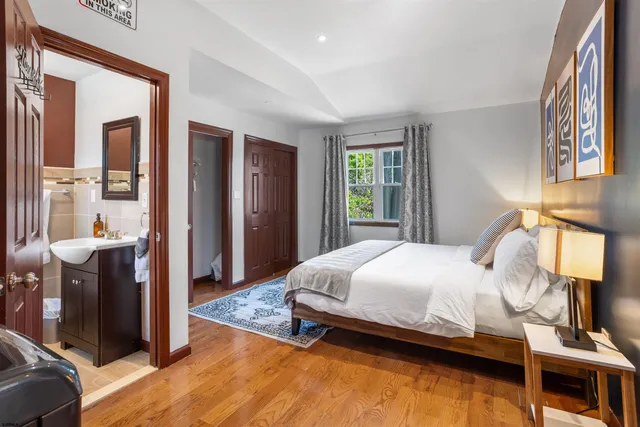 a bedroom with a bed and painting on the wall