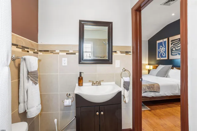 a bathroom with a sink a toilet and a mirror