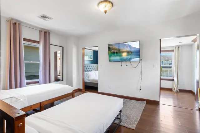 a spacious bedroom with a bed and glass door