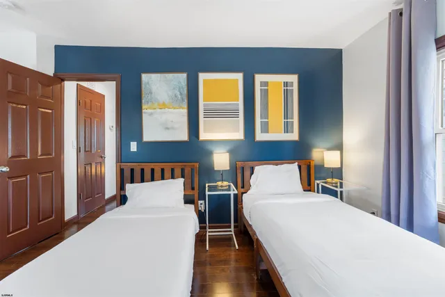 a bed sitting in a bedroom next to a window