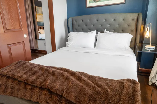 a bedroom with a large bed and a window