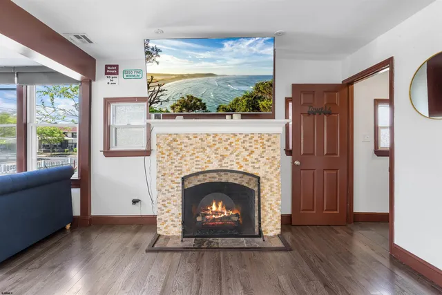 a living room with a fireplace and a floor to ceiling window