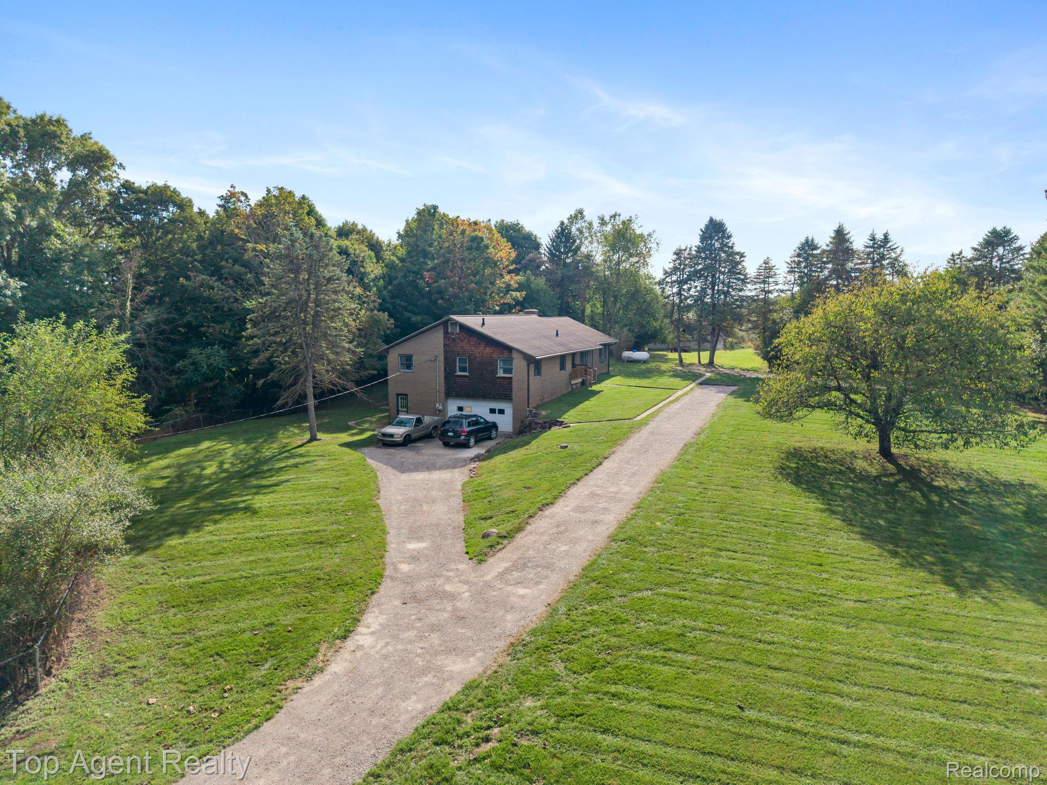 8269 Currie Road Northville, MI 48168 - Photo 66 of 80 Two-story residence with a multi-material exterior and an attached two-car garage