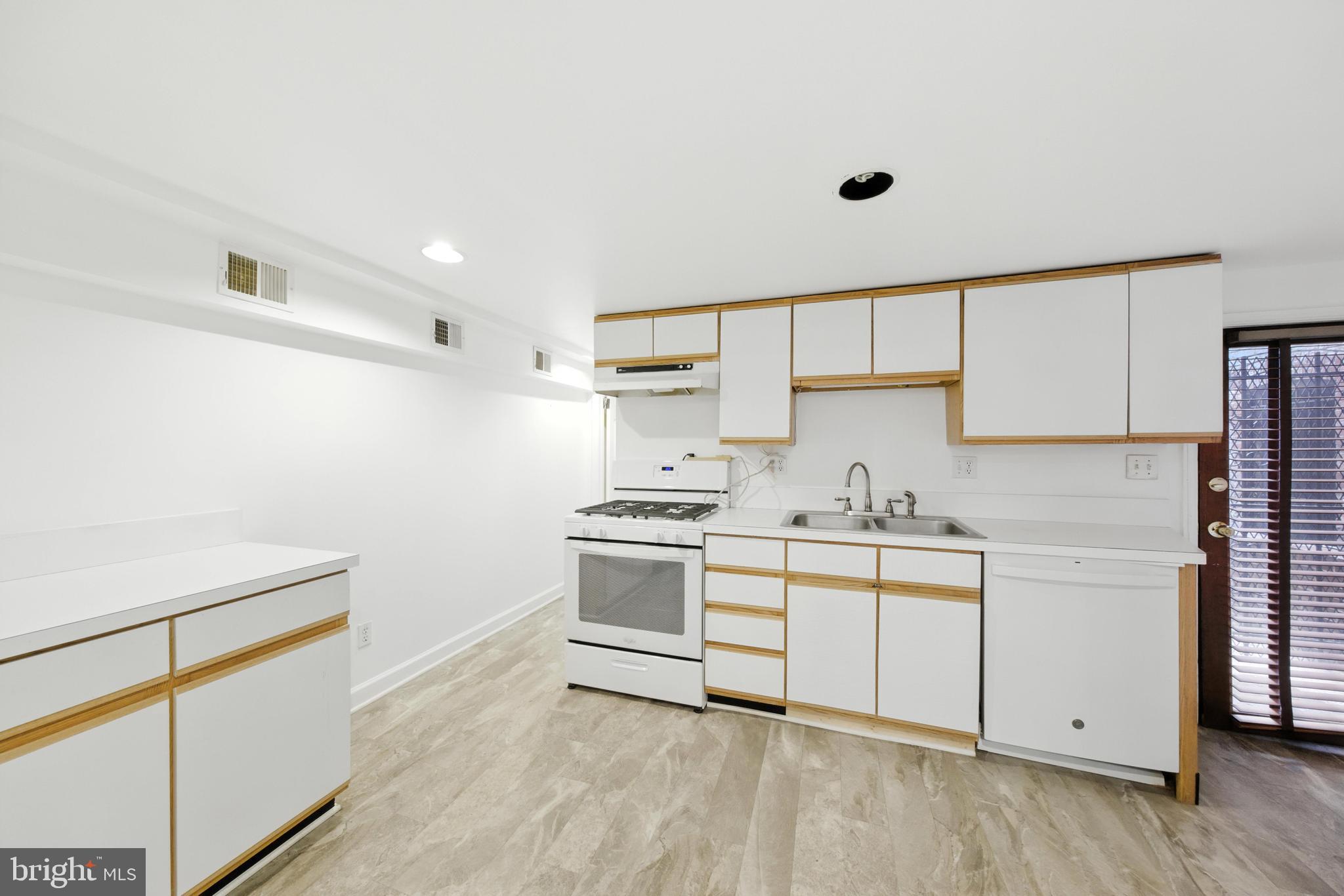 1763 U Street Northwest Washington, DC 20009 - Photo 27 of 29 a kitchen with a sink cabinets and appliances
