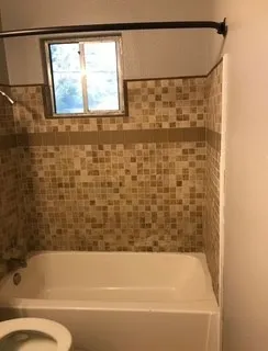 a bathroom with a bathtub and a shower
