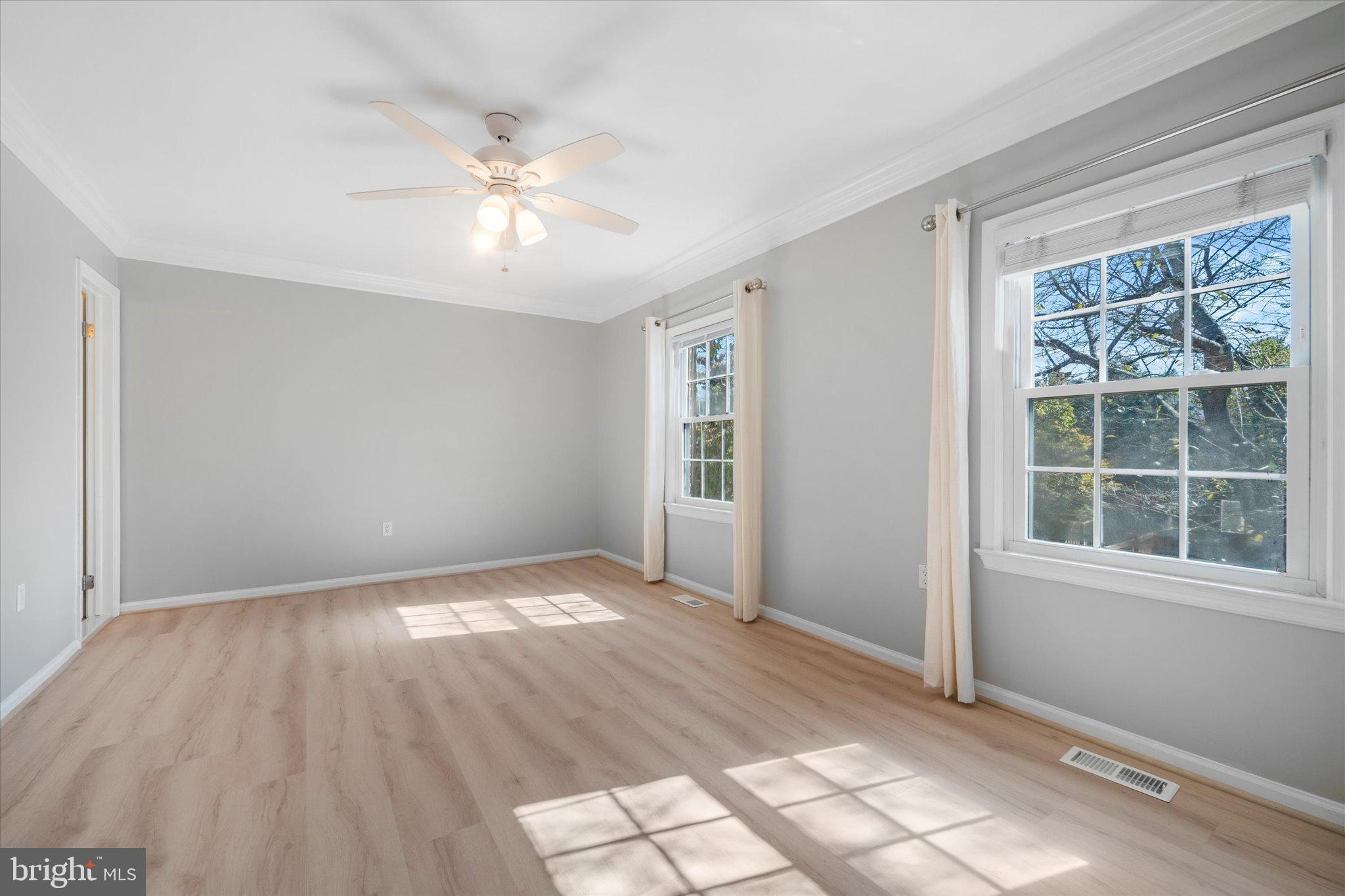 10276 Arizona Circle, Unit 61 Bethesda, MD 20817 - Photo 17 of 42 a view of an empty room with wooden floor and a window
