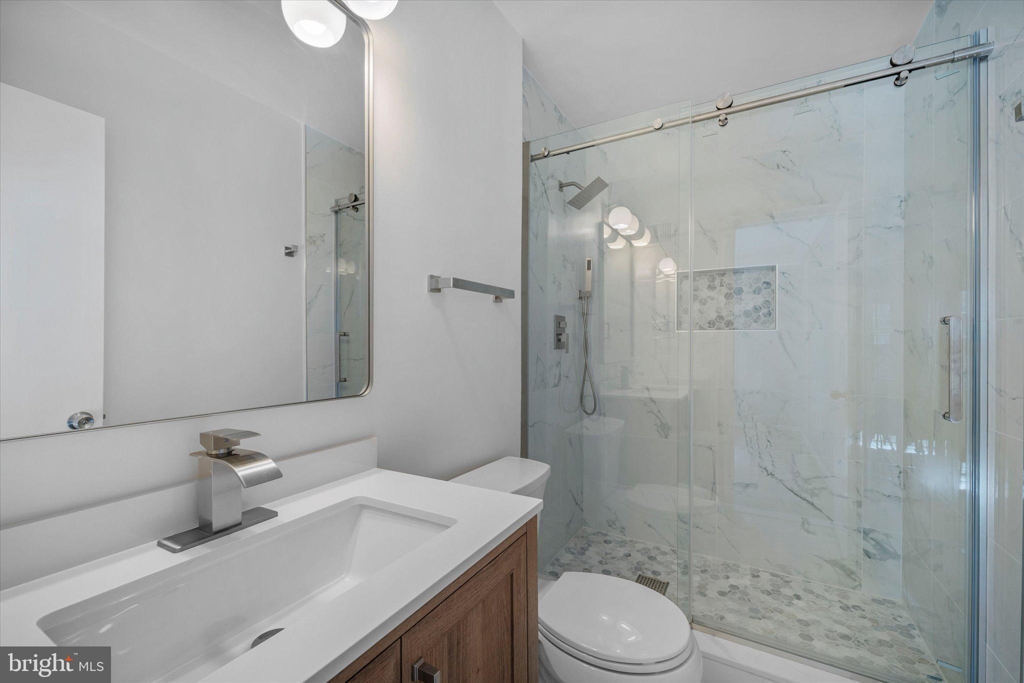 10276 Arizona Circle, Unit 61 Bethesda, MD 20817 - Photo 19 of 42 a bathroom with a sink toilet and shower