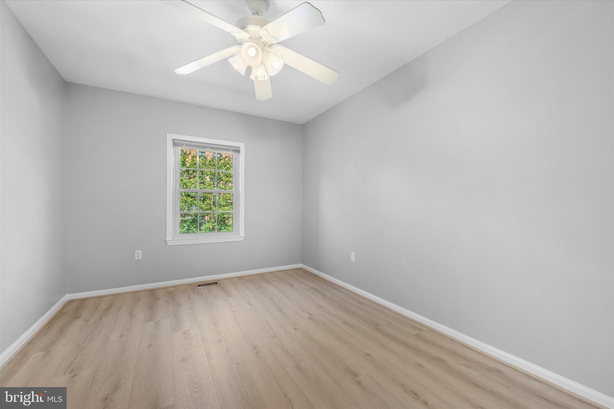10276 Arizona Circle, Unit 61 Bethesda, MD 20817 - Photo 22 of 42 an empty room with a window and a fan